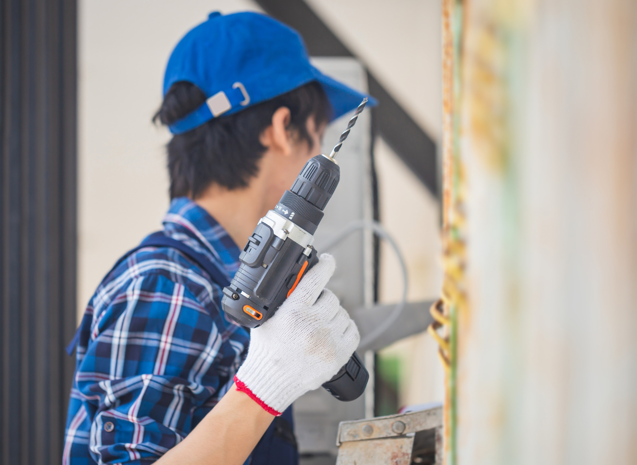 Technician using a cordless drill on a commercial job site | Gaboras Construction